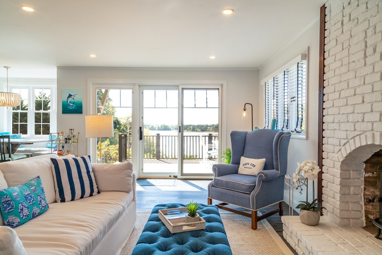 Cape Cod Addition with deck overlooking the bay and fireplace deatail to teh right